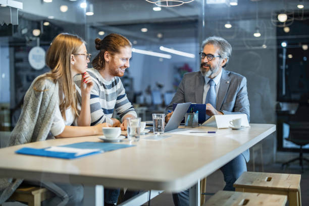 istock Happy couple making plans with their insurance agent in the office. 1342199776