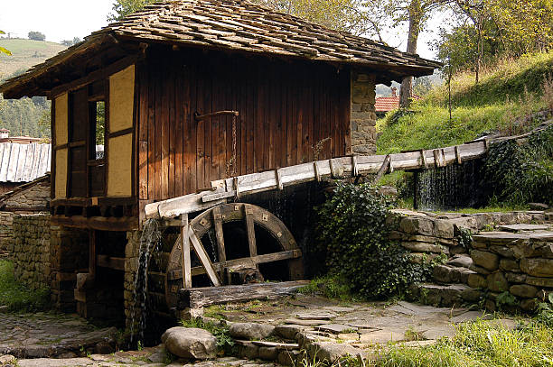 Traditional old wooden watermill in the museum village of Etura, Bulgaria. Still functional, with water running