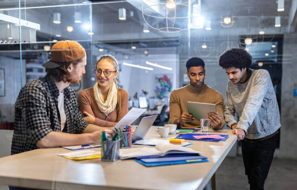 istock Group of young creative people working at casual office. 1342200041
