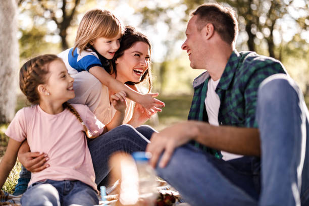 istock Young happy family talking on a picnic in nature. 1342201010