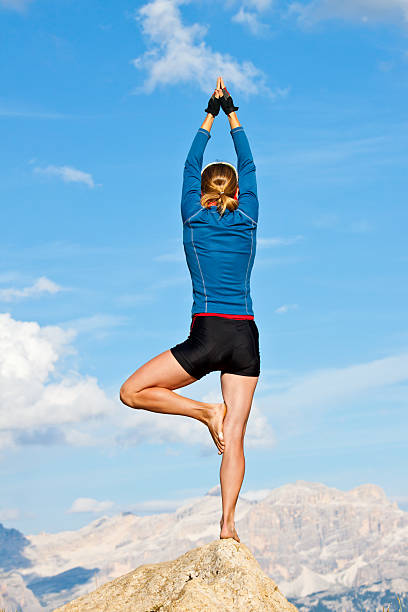 istock Woman doing yoga on rock 134220252