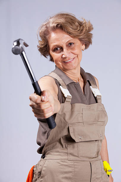 istock senior woman holding a hammer 134220384