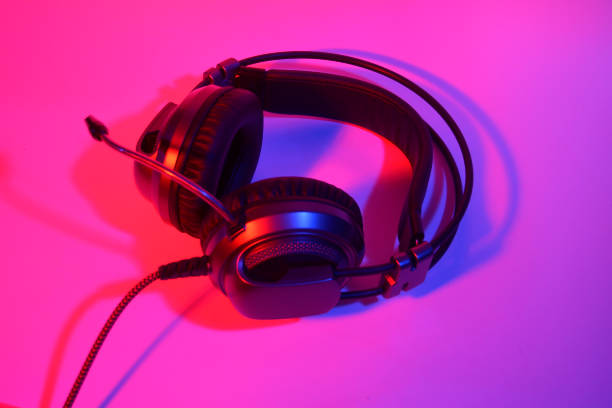istock headphones with microphone in neon top view 1342204814