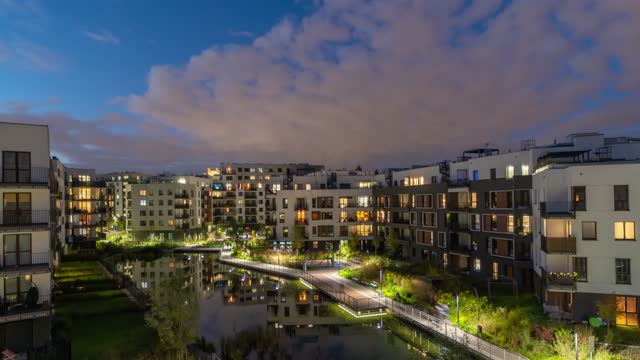 A timelapse of the onset of twilight and night life in the courtyard of a residential quarter of the city