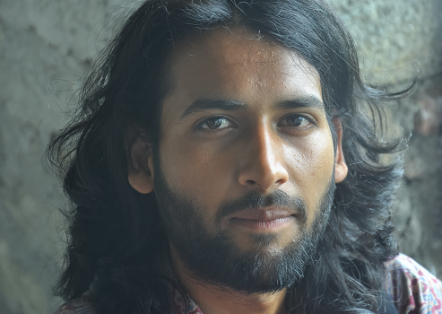 Close Up Shot Of A Attractive Indian Young Man Face With Beard And Long Hair  A Guy Looking At Camera Stock Photo - Download Image Now - iStock