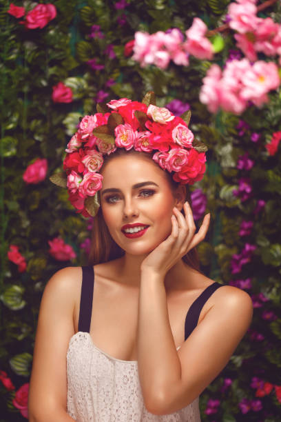 Beautiful woman with flowers wreath Beautiful young woman beauty and fashion portrait with wreath headband in flowers garden floral crown photos stock pictures, royalty-free photos & images