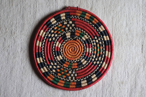 A top shot of a woven mat from Uganda, made using a traditional spiral African basket weaving pattern