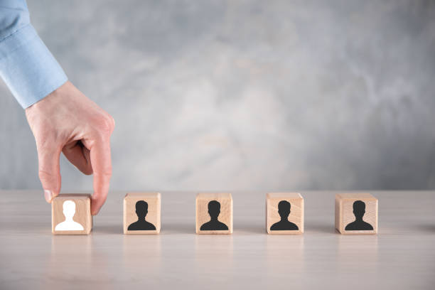 istock Businessman hold and put wooden cube block shape with user icon on grey table. Space for text. Internet icons interface foreground. global network media concept,contact on virtual screens ,copy space 1342208614