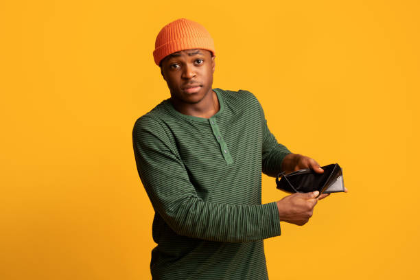istock Poverty Concept. Upset Young Black Man Showing Empty Wallet At Camera 1342209764