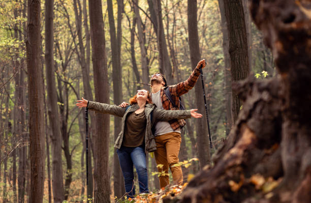 istock Young couple with backpack hiking in forest. 1342211347