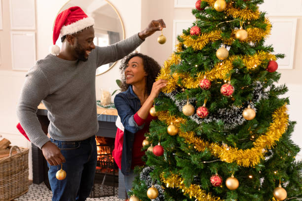 istock Happy african american couple decorating christmas tree 1342212154