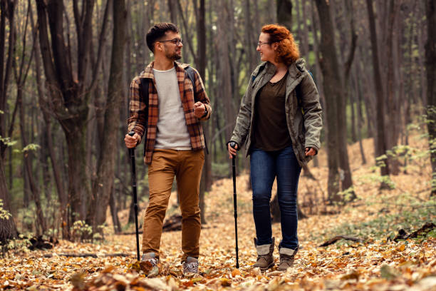 istock Young couple with backpack hiking in forest. 1342213195