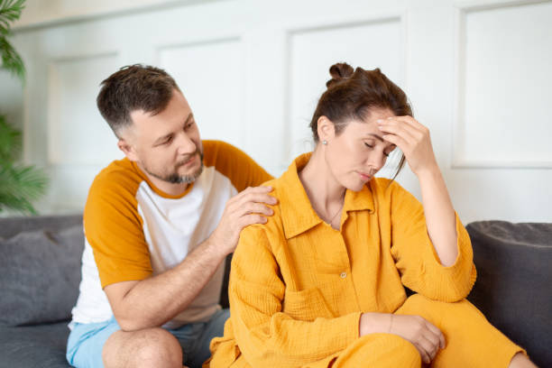 Family problems. A man tries to talk to a woman. Support in difficult times stock photo