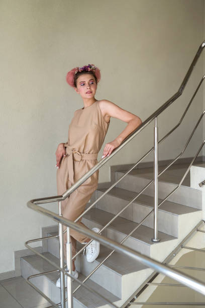 istock Young lady posing on the stairs inside building 1342218985