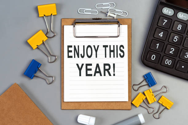 istock The words Enjoy this year written on a white notebook. Work and study concept 1342220464