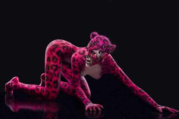 cat-girl bodyart painted in the form of a Pink panther on the black background body paint stock pictures, royalty-free photos & images