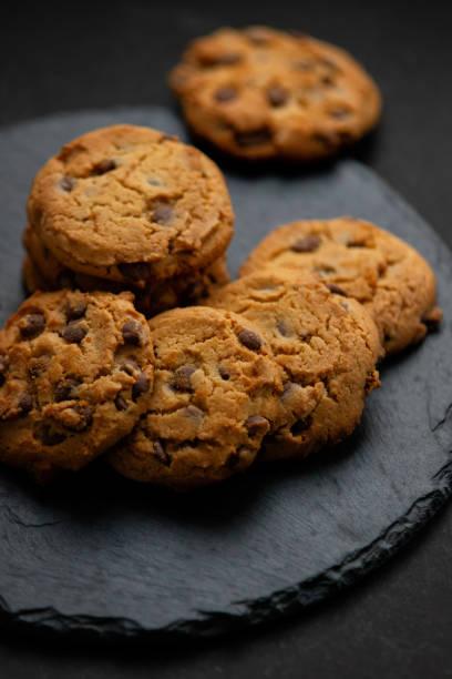 istock Fresh crispy chocolate chip cookies on a dark table 1342221429