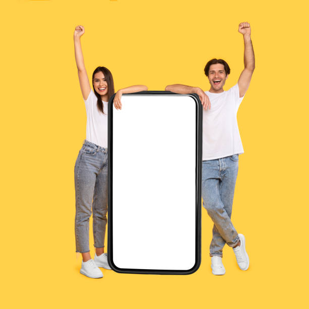 istock Couple showing white empty smartphone screen and making win gesture 1342221968