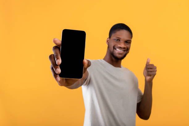 istock Joyful african american man demonstrating smartphone with empty screen, showing copy space for your ad or design 1342221999