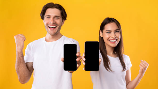 istock Couple showing two empty smartphone screens gesturing yes 1342223081