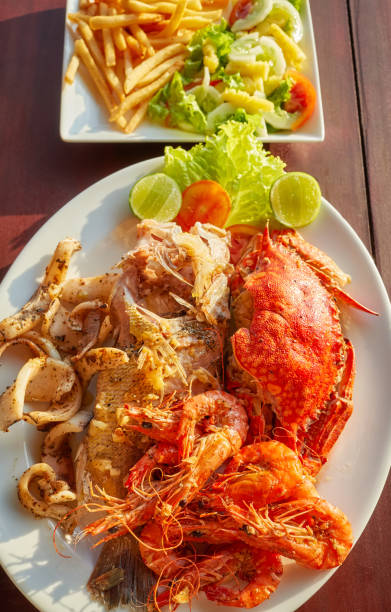 istock Grilled seafood platter with crab, fish, prawn and squid with lemon. 1342223439