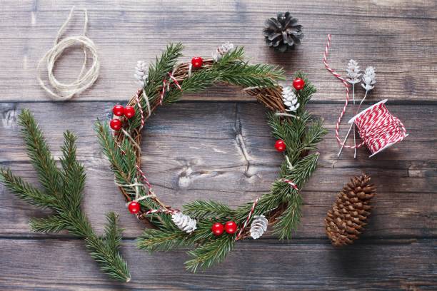 istock Christmas wreath and gift boxes on wooden background, greeting card template 1342223507