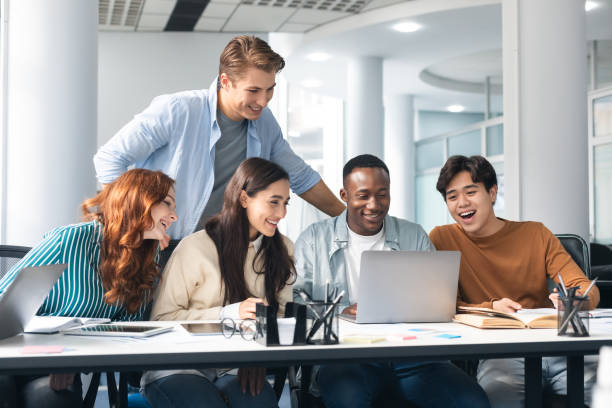 istock Diverse group of people sitting at desk and using pc 1342224960