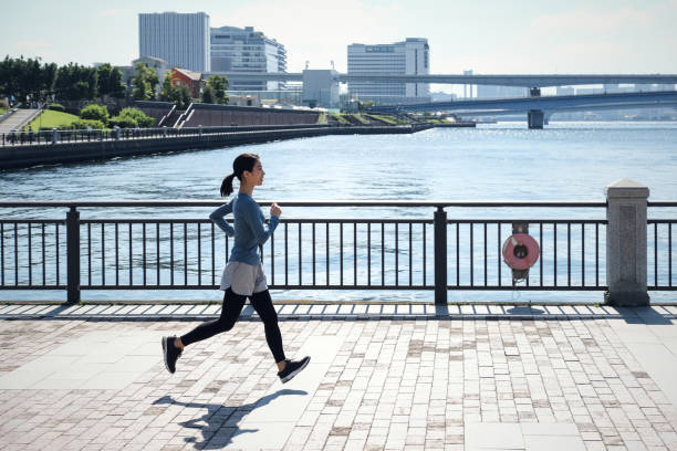 Young woman running on the seaside walkway