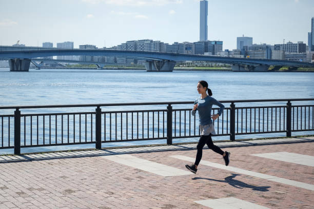 istock Young woman running on the seaside walkway 1342226142