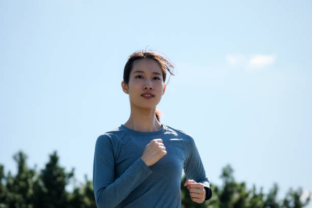 istock Woman running in office park 1342226274