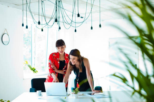 Female coworkers discussing in the creative office