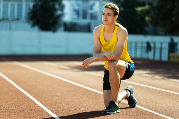 istock One young sportive man, male athlete, runner practicing alone before race at public stadium, sport court or running track, outdoors. Professional sport games. 1342227125