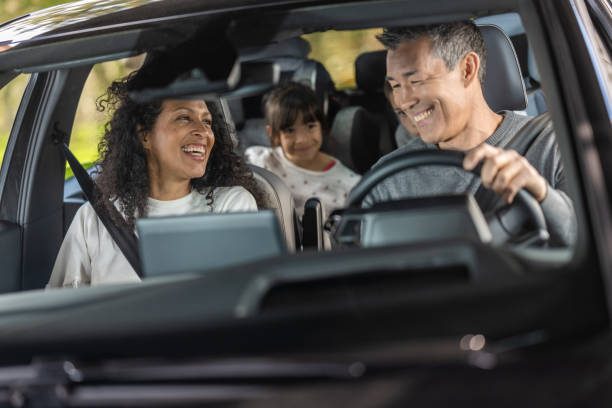 Happy family enjoying in car during road trip stock photo