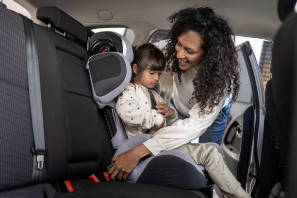 istock Woman fastening her daughter's seat belt 1342227192