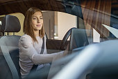 Woman using global positioning system in car