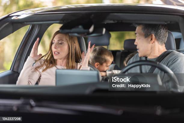 Frustrated Parents Arguing During Trip By A Car Stock Photo - Download Image Now - Car, Driving, Family