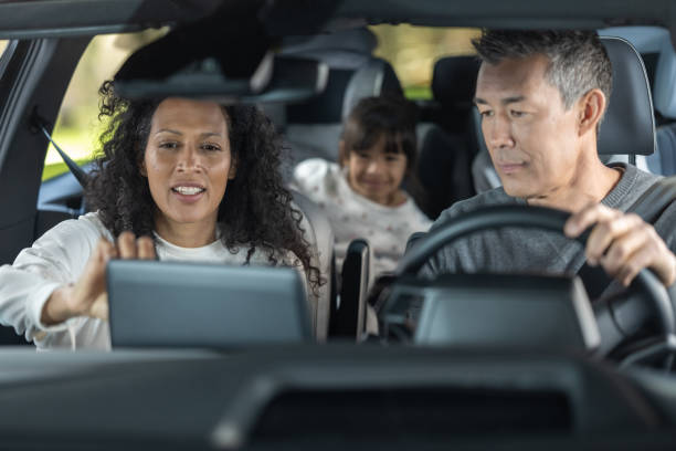 Happy family enjoying in car during road trip stock photo