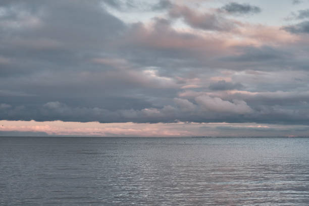 istock Beautiful dramatic cloudy sky over sea bay at sunset 1342228429