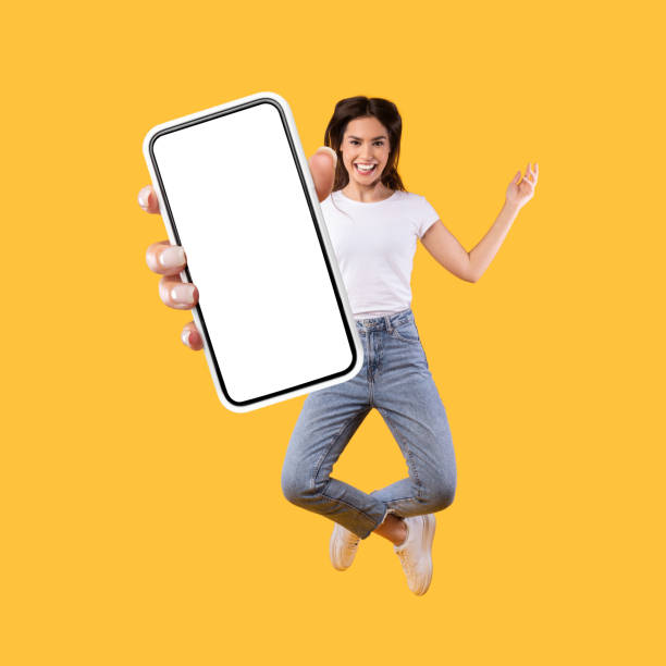 istock Woman showing white empty smartphone screen and jumping up 1342228749