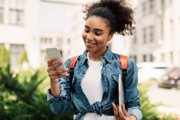 istock Happy Black College Girl Using Smartphone Texting Outdoor 1342228791