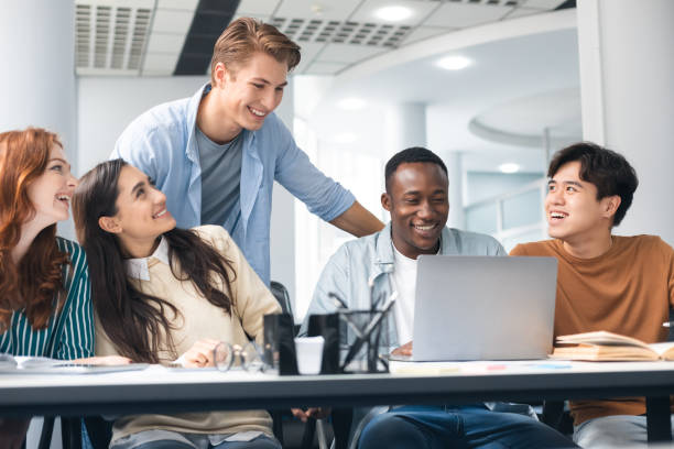 International group of people sitting at desk and using pc