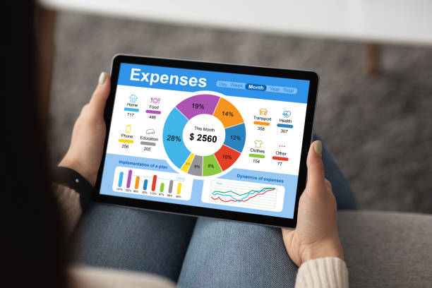 Unrecognizable woman with pad, calculating her monthly spendings