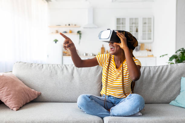 istock Millennial black woman using VR glasses at home 1342229223