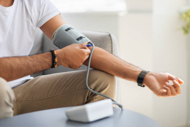 istock Unrecognizable male patient using modern tonometer at home 1342229861