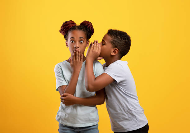 istock Black boy brother sharing secrets with his older sister 1342230176