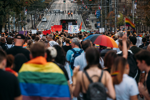 Rear view of people marching down the street at a pride parade in Belgrade, Serbia, on September 18th, 2021