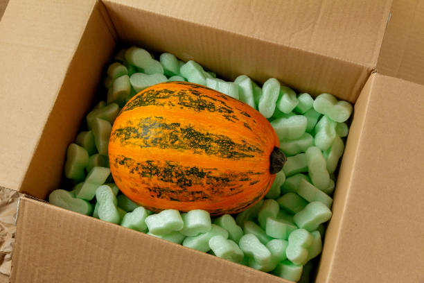 istock Pumpkin in a cardboard box with soft polystyrene foam 1342233757