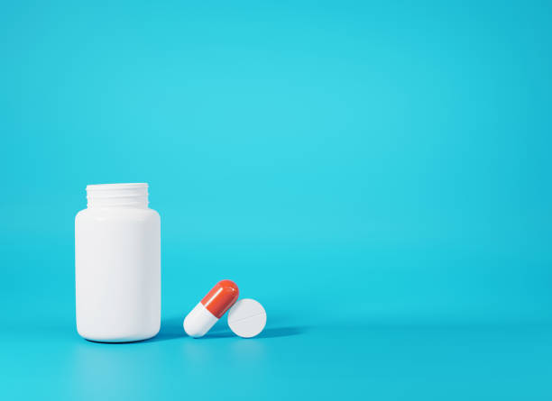 istock Medical pill or tablet and bottle on blue background 1342233871