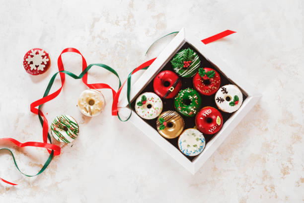 Colorful doughnuts in a gift box and beside. Christmas  Doughnuts with sugar icing  as a gift