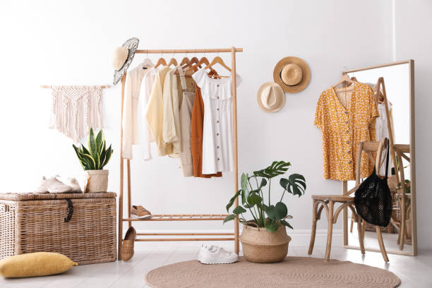 istock Rack with stylish women's clothes and mirror indoors. Interior design 1342234743